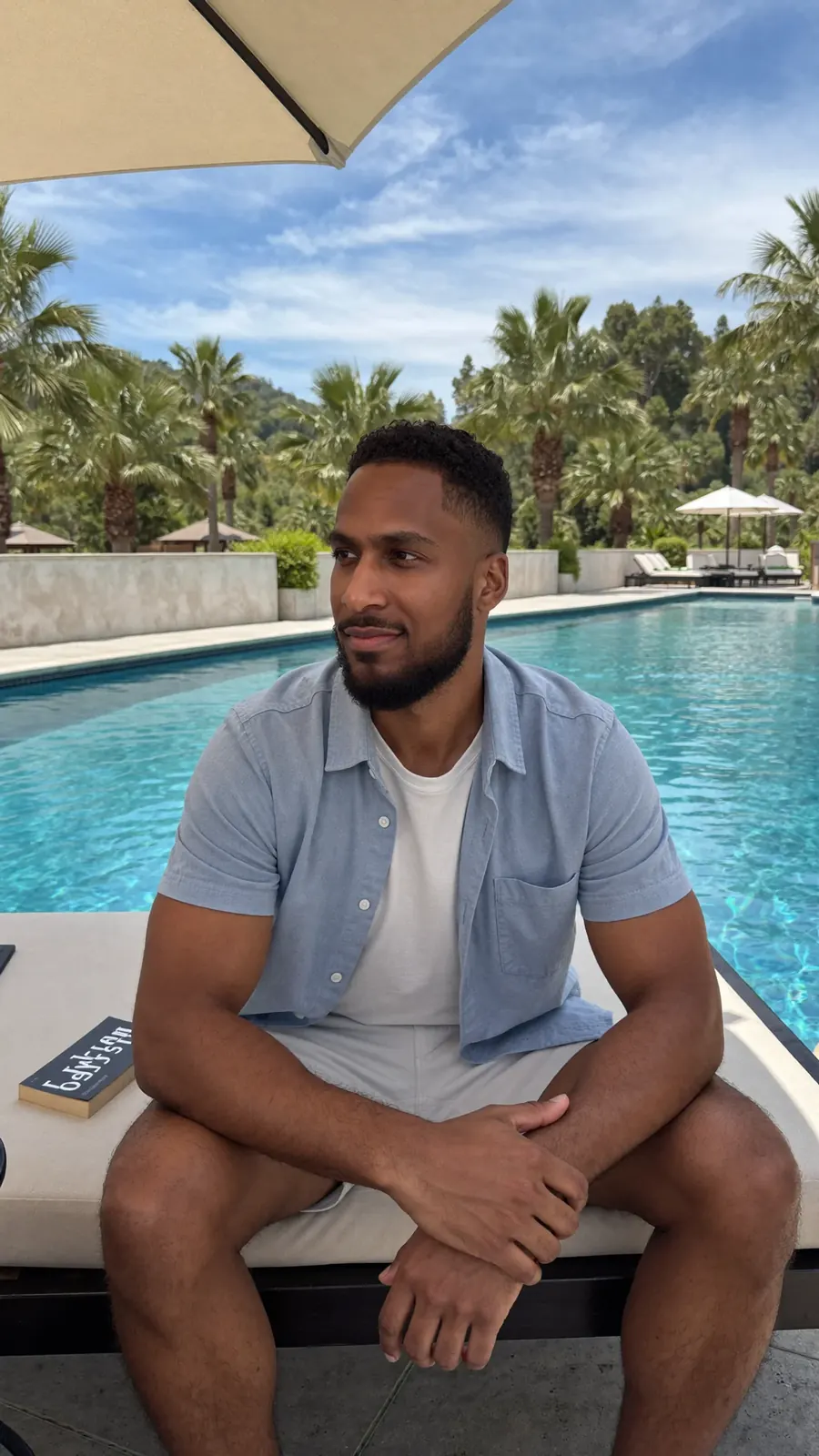 King The Kemist seated outdoors by the water
